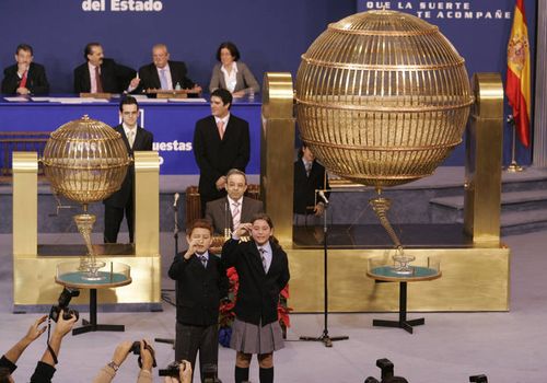 Two schoolchildren call out the winning number during Spain's El Gordo lottery in Madrid