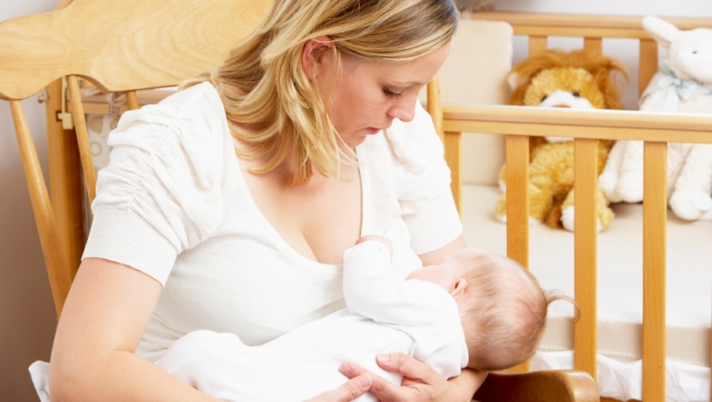 Mother Breastfeeding Baby In Nursery