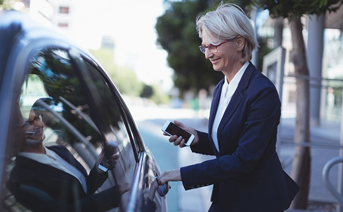 Businesswoman opening car door