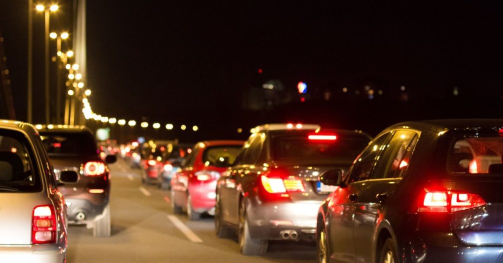 Cars in traffic jam in city by night