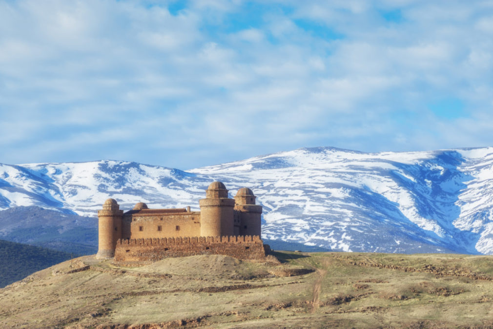 Castle Calahorra with the snow capped mountains of the Sierra Nevada, Granada Province, Andalusia, Spain.