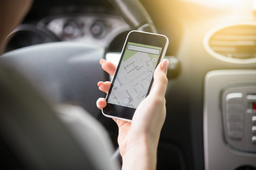 Close-up of female hand holding her phone using navigation syste