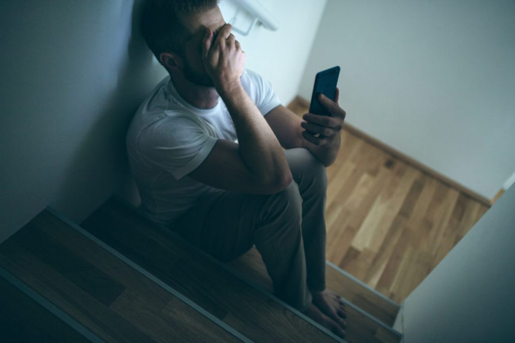 Depressed man sitting in the dark