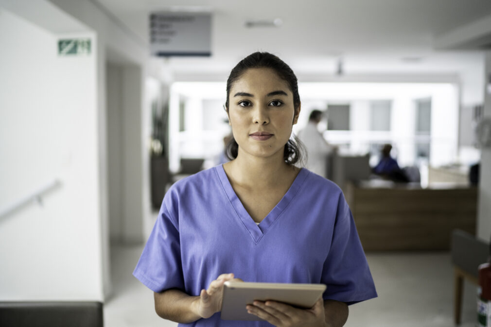 Portrait of female nurse using tablet at hospital