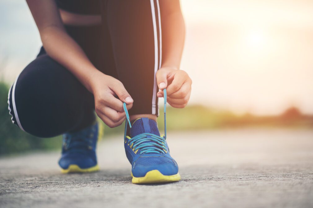 Close up shoes Female runner tying her shoes for a jogging exerc