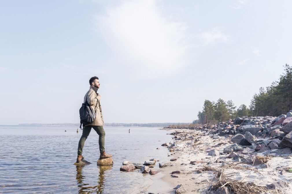 young-male-traveler-with-is-backpack-looking-view