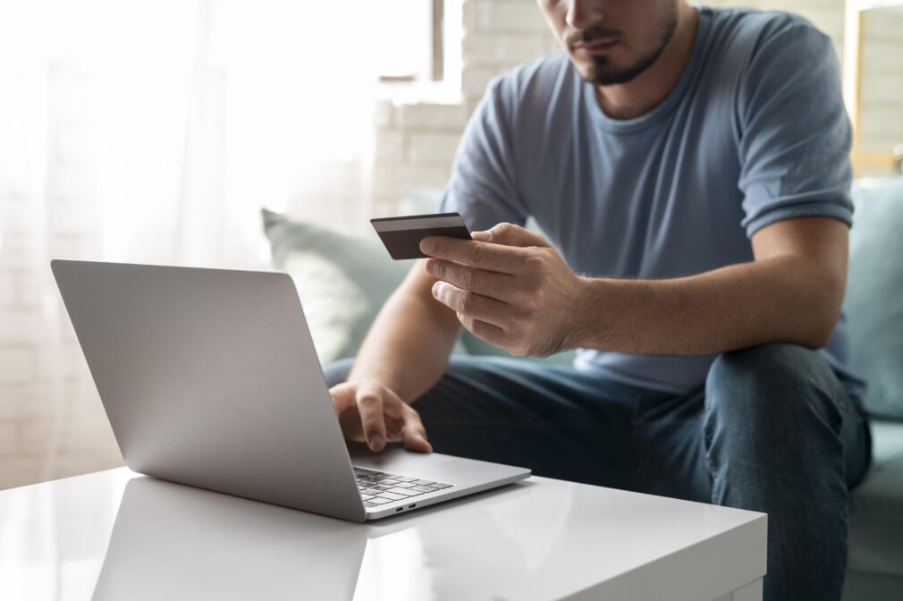 hombre-usando-su-tarjeta-de-credito-para-jugar-en-linea-para-un-pedido