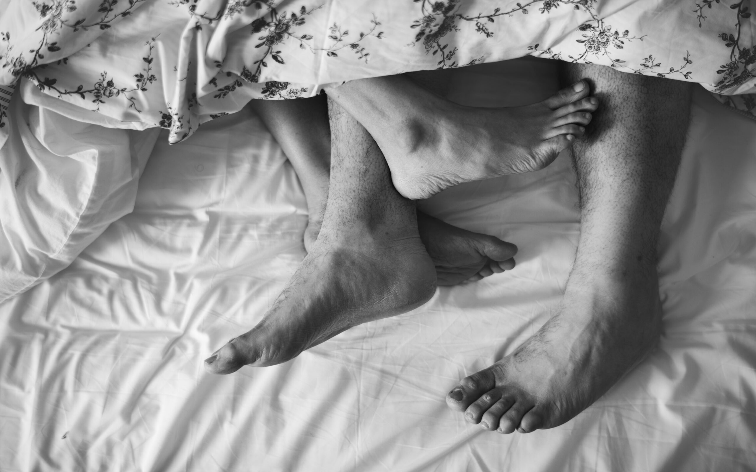Aerial view of legs on bed